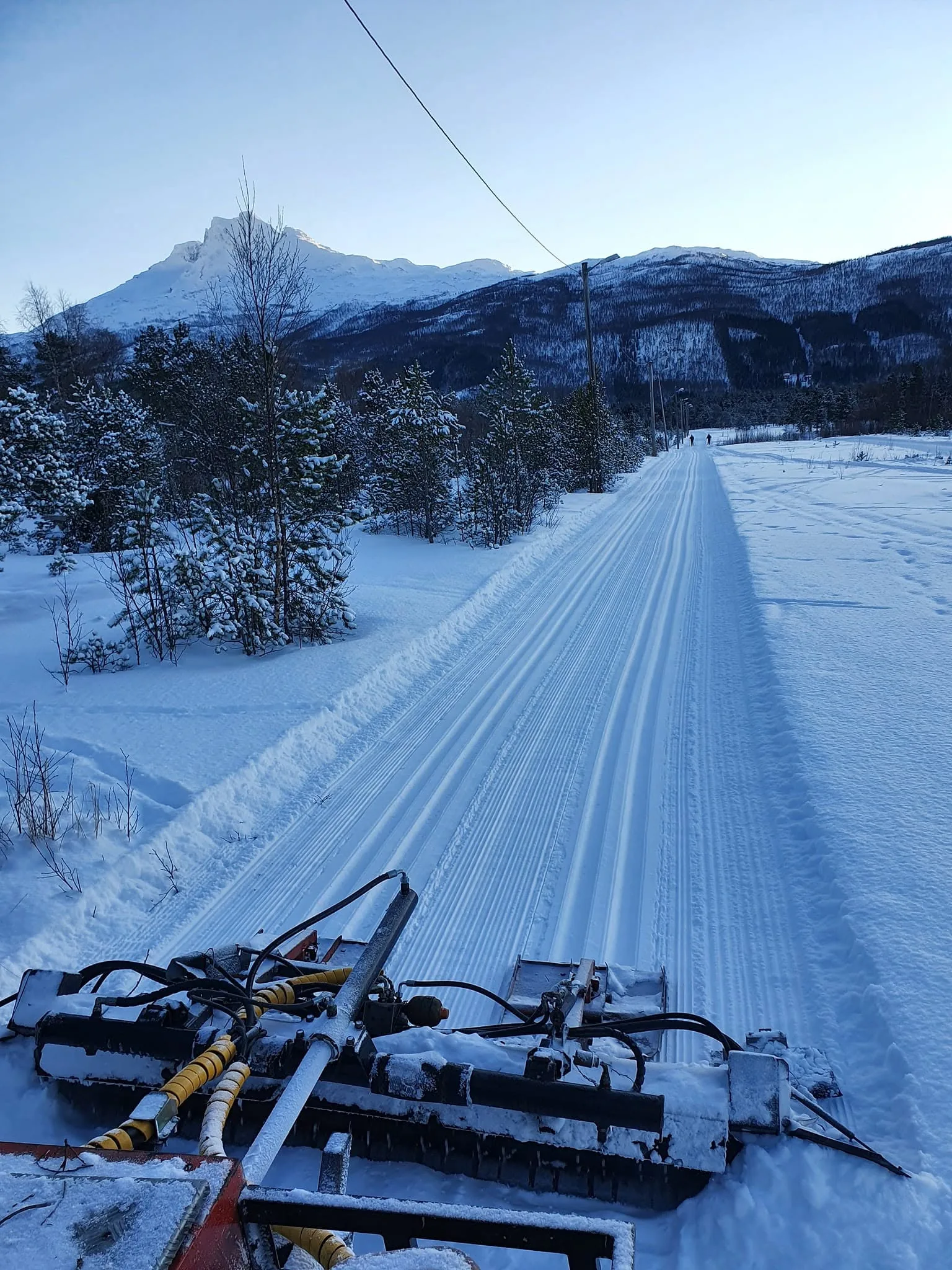 Nykjørte skispor i lysløypa med fjell i bakgrunnen